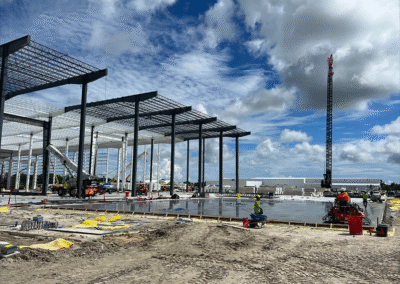 Zamora Concrete crew pouring and leveling concrete at SpaceX hangar site