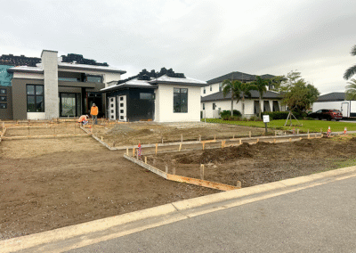 Angled view of custom concrete driveway with inlay design by Zamora Concrete